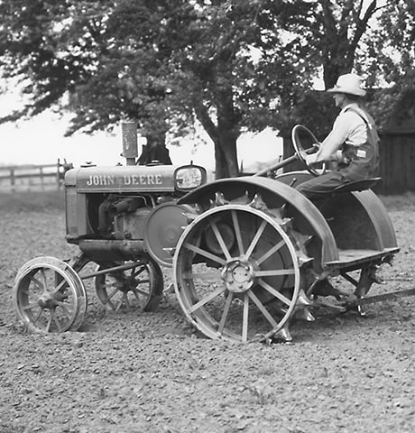 Historical John Deere “GP” General Purpose Tractor pulling a John Deere No. 7 Rotary Hoe in field